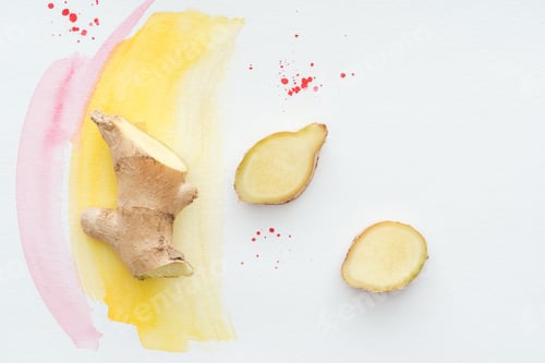 Preview: top view of sliced ginger root on white surface with yellow watercolor strokes