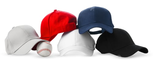 Preview: Colorful Assortment of Baseball Caps and a Ball on White Background