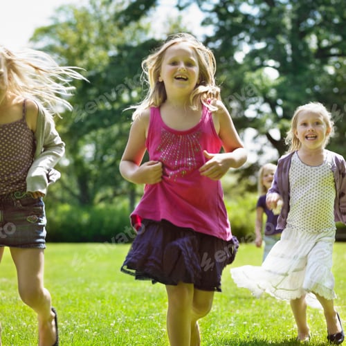 Preview: Smiling girls running in field