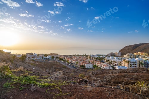 Preview: Scenic view of Palm-Mar, Tenerife at sunset with residential buildings and the ocean