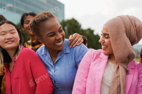 Preview: Group of happy young multiracial people having fun together in the city