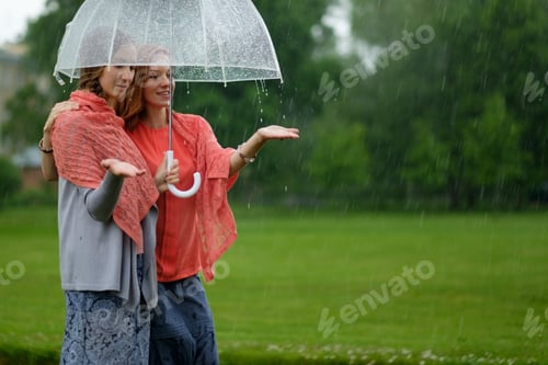 Preview: Two women walking park in rain and talk. Friendship and people communication.
