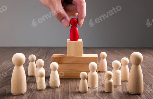 Preview: Businessman hand choose people standing out from the crowd.