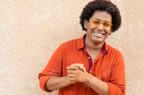 Preview: Cool ethnic man with sunglasses looking at the camera