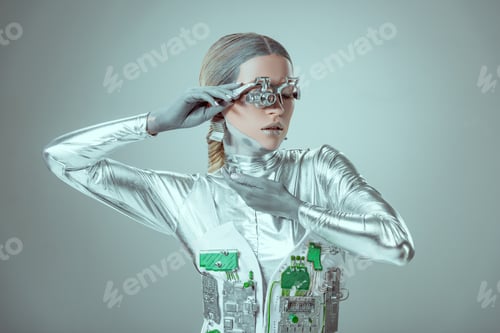 Preview: young woman robot posing isolated on grey, future technology concept