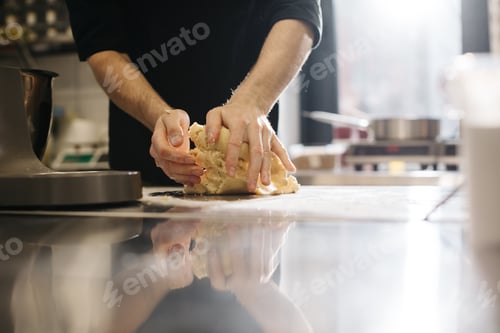 Preview: Close up. The cook kneads the dough with his hands, making macaroons or cakes.
