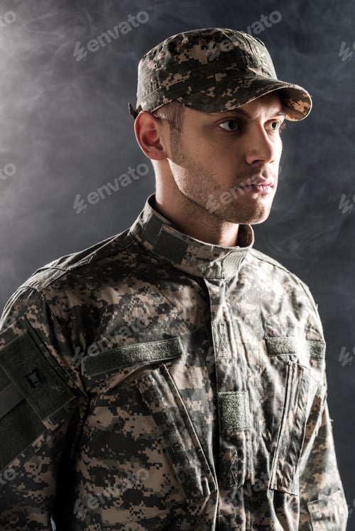 Preview: Contemplative Young Man Wearing Camouflage Uniform and Hat