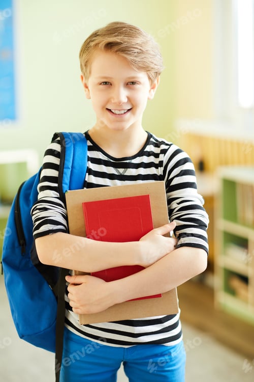 Preview: Happy schoolboy with workbooks