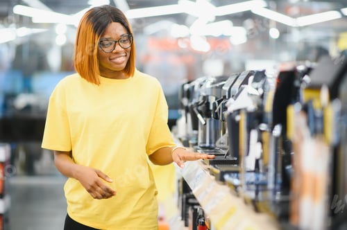 Preview: Smart modern african american female customer choosing coffee machine at electronics store