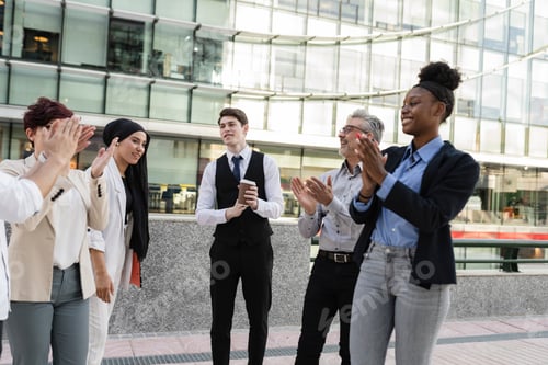 Preview: and businesswomen applauding with multiethnic colleagues at outdoor seminar.