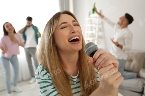 Preview: Young woman singing karaoke with friends at home