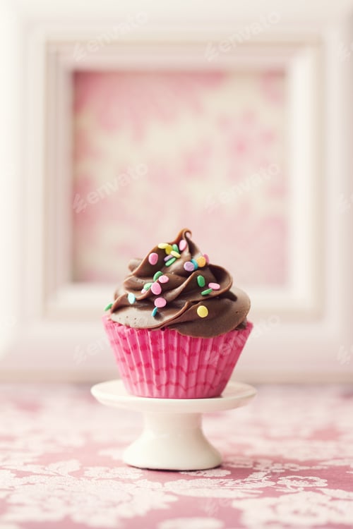 Preview: Delicious Chocolate Cupcake with Sprinkles and Pink Wrapper