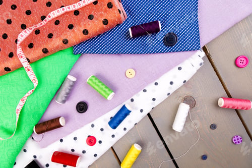 Preview: Items for sewing clothes. Sewing buttons, spools of thread and cloth. Top view.