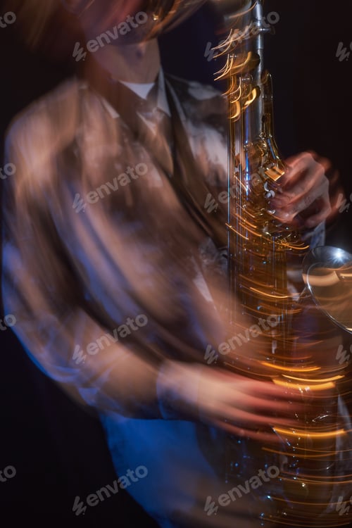 Preview: Saxophone in Hands of Male Jazz Musician Performing on Stage in with Dim Light