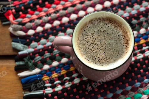 Preview: Cup of coffee on wooden background with textile hand-woven rag rug. Copy space, top view.