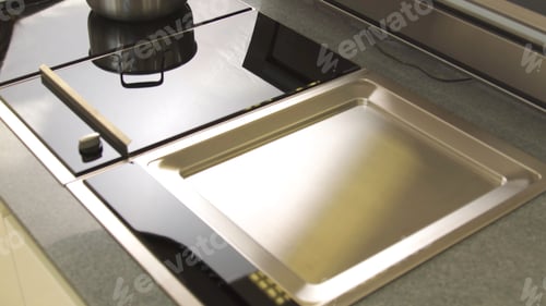 Preview: A freshly cleaned glass surface of an electric cooker built into the kitchen worktop. Household