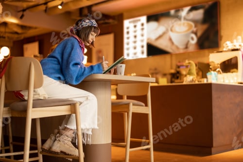Preview: Woman works on touchpad at coffee shop