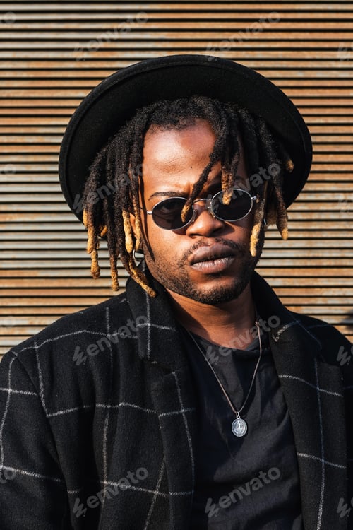 Preview: Stylish black man with dreadlocks on street