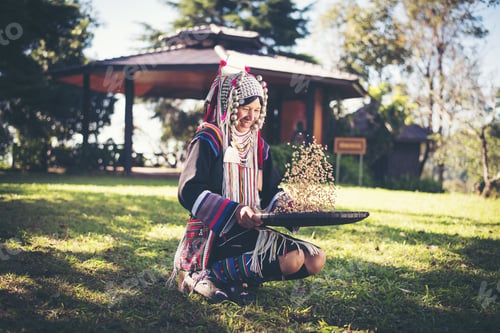 Preview: Akha in the north of Thailand enjoying coffee from shell by bamboo basket with traditional cloth.