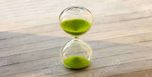 Preview: Hourglass with green sand on a wooden background