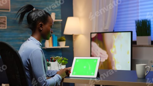 Preview: Focused black manager woman looking at tablet with green screen