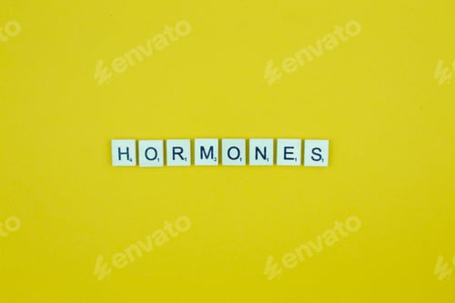 Preview: Hormones- scrabble letters word on a yellow background
