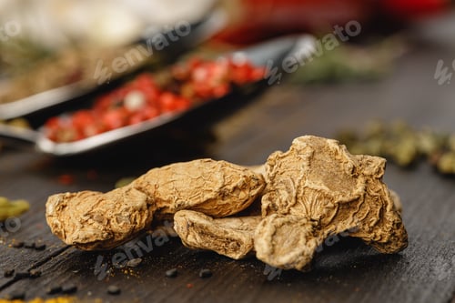 Preview: Dried ginger on dark wooden table close up