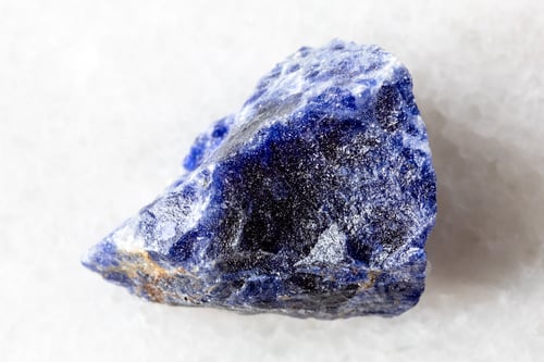 Preview: sample of raw sodalite mineral on white marble