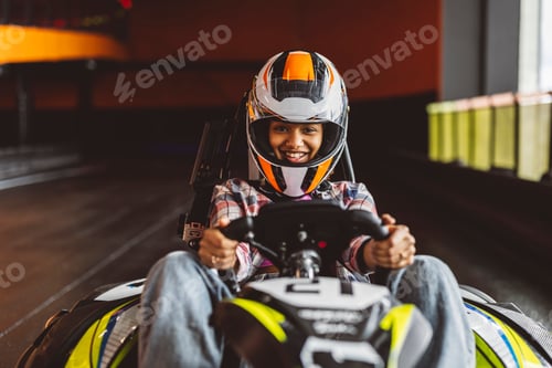 Preview: portrait of young african american woman looking at camera wearing helmet