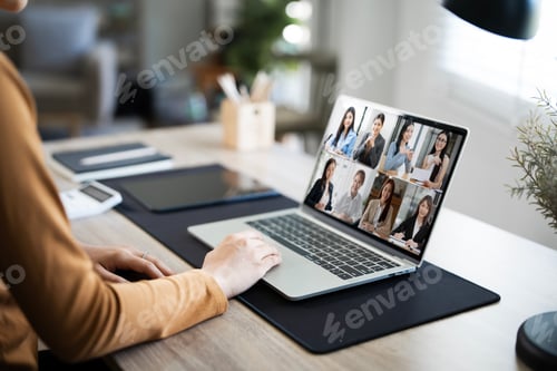 Preview: Back view of female employee speak talk on video call with colleagues online,