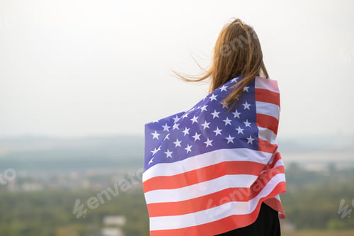 Preview: Woman Displaying American Flag Outdoor on Sunny Day