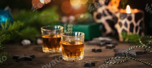 Preview: Two glasses of whiskey or bourbon with Christmas decoration