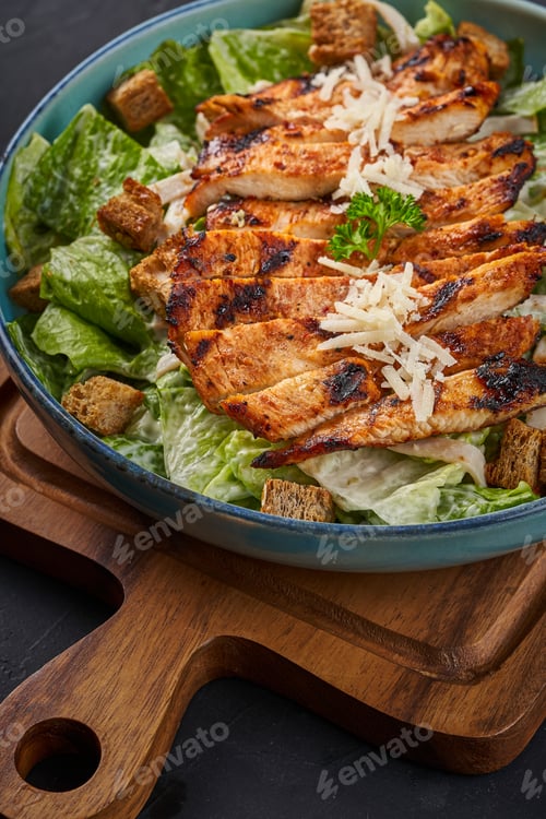 Preview: Close-up of chicken strips in a plate with vegetables and cheese