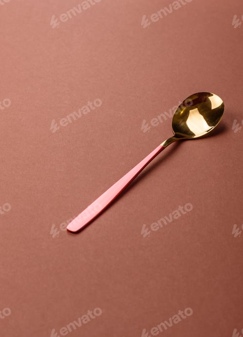 Preview: Empty metal spoon on a monochrome brown background