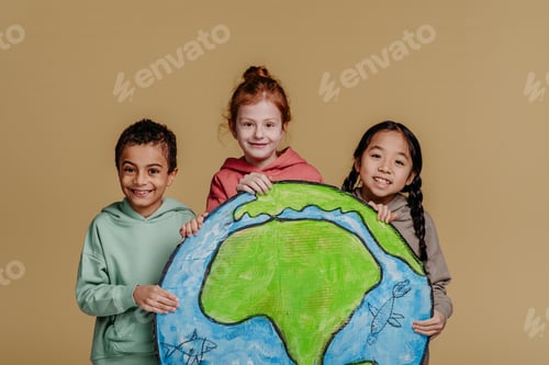 Preview: Portrait of three children with model of Earth, studio shoot. Concept of diversity in friendship.