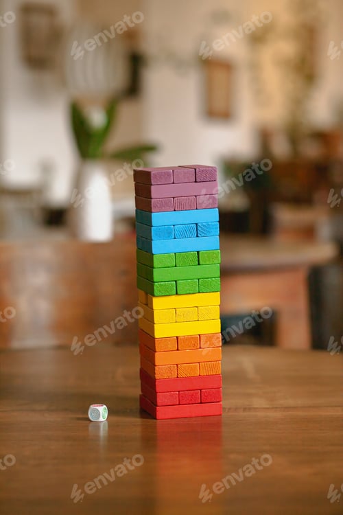 Preview: A young couple of a guy and a girl play colored jenga