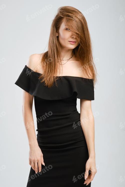 Preview: Studio portrait of young woman in black dress