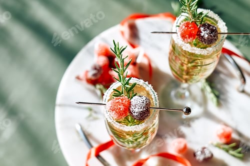 Preview: Christmas cocktail with sparkling wine, rosemary and cherry. Winter holidays champagne drink.