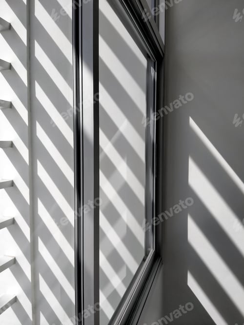Preview: Sunlight and shadow of sunshade battens on surface of glass window in perspective side view