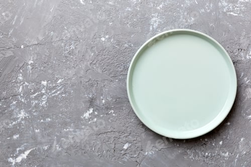 Preview: Top view of empty blue plate on cement background. Empty space for your design