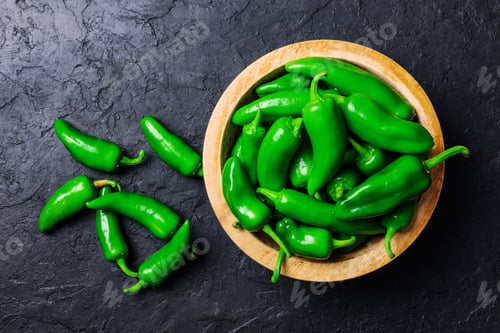 Preview: Green jalapeno hot pepper in wooden plate