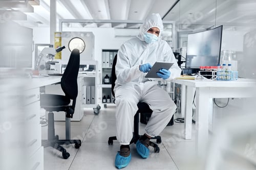 Preview: Man in Protective Suit Working in Laboratory