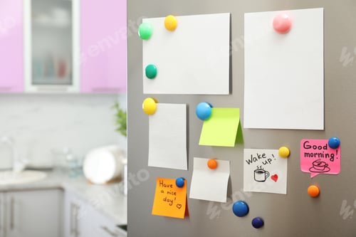 Preview: Many notes and empty sheets with magnets on refrigerator door in kitchen. Space for text