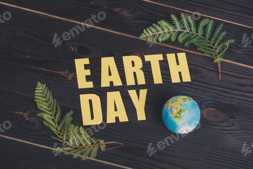 Preview: wooden calendar with date"22 april" and green fern leaf on light green background