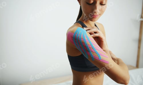 Preview: Woman with Kinesiology Tape on Arm Indoors