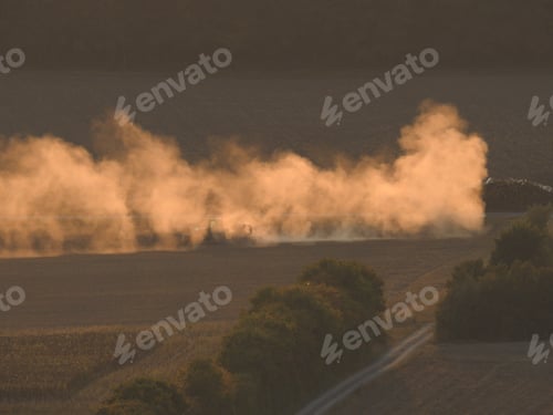 Preview: Agricultural field during harvest time with industrial combine machine in working prosses
