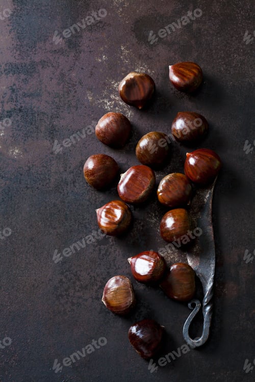 Preview: Sweet chestnuts and old knife on rusty ground