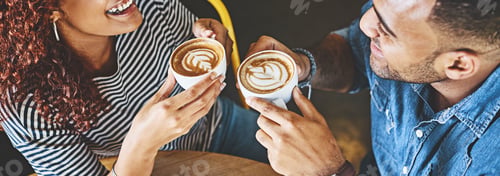 Preview: Cropped shot of a happy young couple sitting together in a cafe and enjoy a coffee during a date