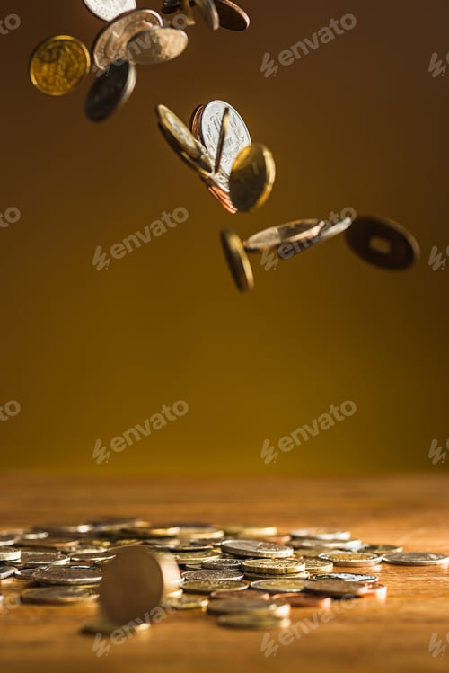 Preview: The silver and golden coins and falling coins on wooden background