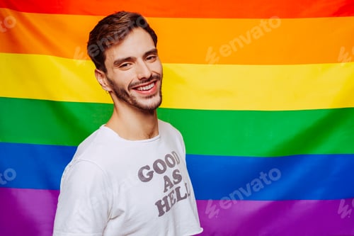 Preview: Cheerful gay man over rainbow flag